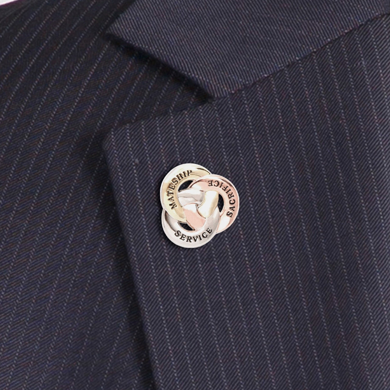 Crafted with meticulous attention to detail, this lapel pin features three interlocked rings made of zinc alloy, each with a unique message. One ring in copper is engraved with "Sacrifice", another in silver with "Service", and the third in gold with "Mateship". Together, they symbolize the unwavering values that Australian soldiers hold dear. www.moralepatches.com.au