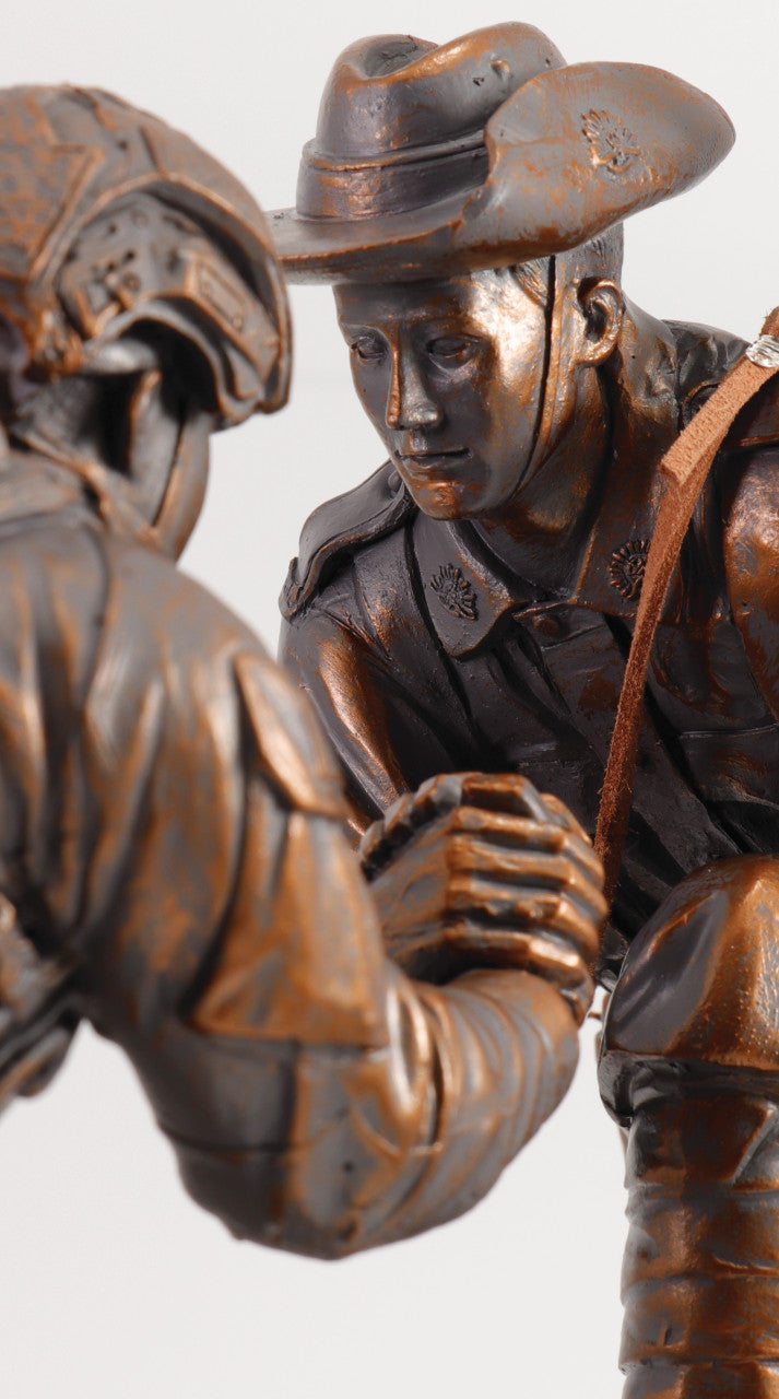 The "Spirit of Mateship Limited Edition Figurine" is a poignant and timeless tribute that captures the unwavering bond and camaraderie of Australian soldiers across generations. This exquisite cold cast bronze figurine, perched atop a timber base, depicts a powerful scene—a WW1 digger extending a helping hand to a modern Australian soldier, navigating a treacherous and muddy battlefield. www.moralepatches.com.au
