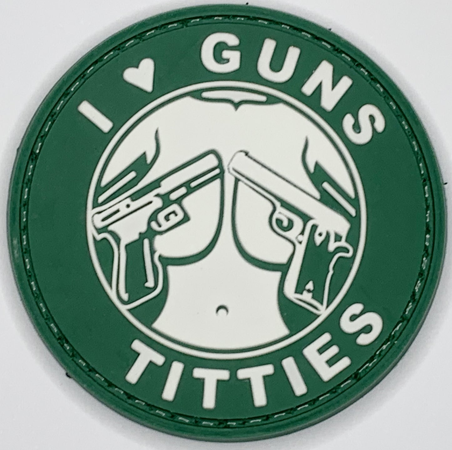 I Love Guns and Titties PVC Patch, Velcro backed Badge. Great for attaching to your field gear, jackets, shirts, pants, jeans, hats or even create your own patch board. Size: 6cm