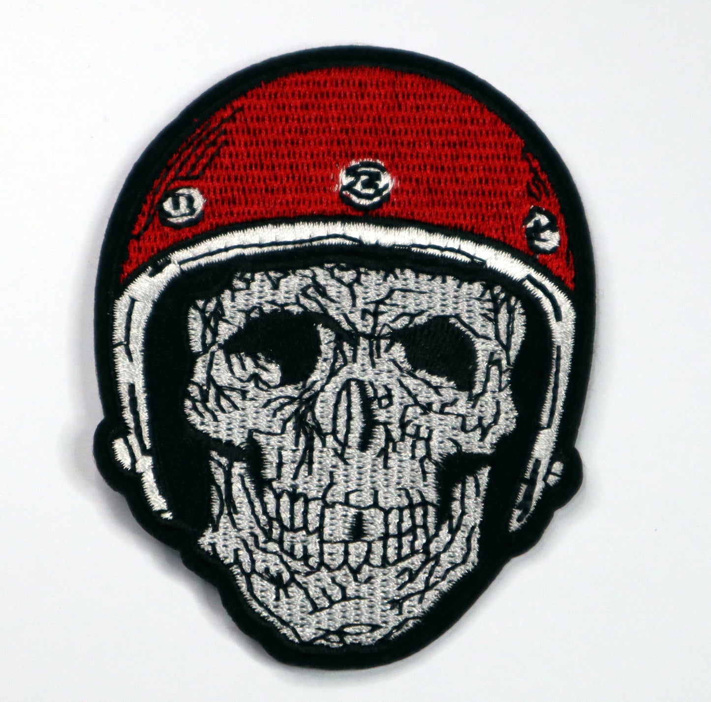 Skull with red helmet Iron On Patch. Great for attaching to your jackets, shirts, pants, jeans, hats. Size: 7x9.2cm