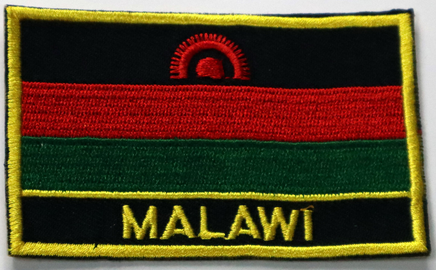 Malawi Flag Iron On Patch. Great for attaching to your jackets, shirts, pants, jeans, hats. Size: 8x5cm