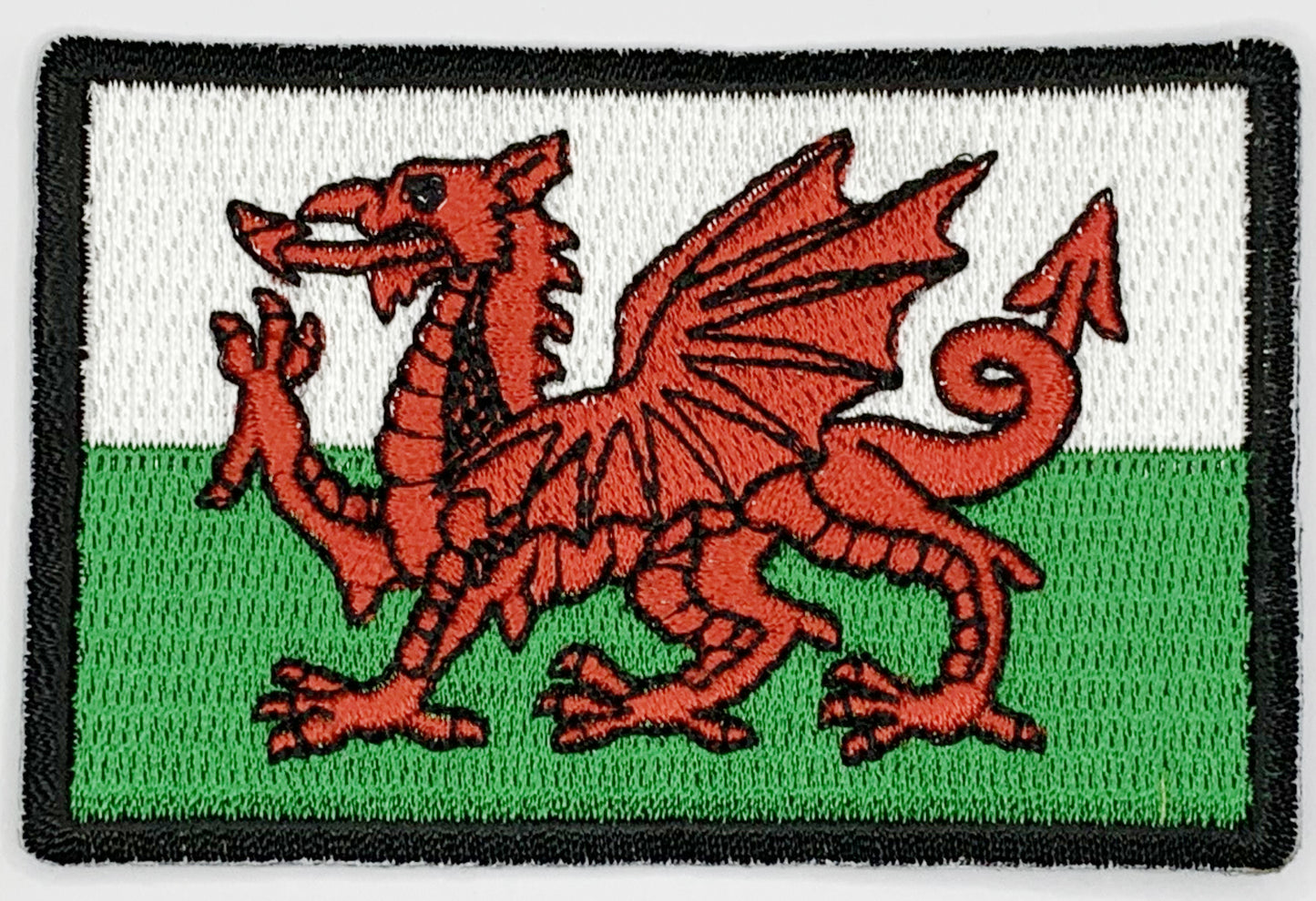 Wales Flag Iron On Patch. Great for attaching to your jackets, shirts, pants, jeans, hats. Size: 7.62x5.08cm