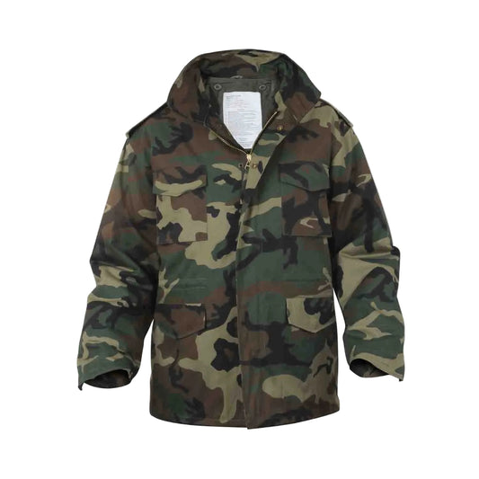 The M65 Field Jacket Parker in Woodland Camo delivers authentic military heritage with practical, everyday versatility. Built from heavy-weight poly/cotton, this hard-wearing jacket withstands harsh conditions while the removable polyester liner adapts to any season — spring through winter. The concealed hood tucks away when not needed, and the brass hardware with storm flap keeps you protected in unpredictable weather. www.moralepatches.com.au