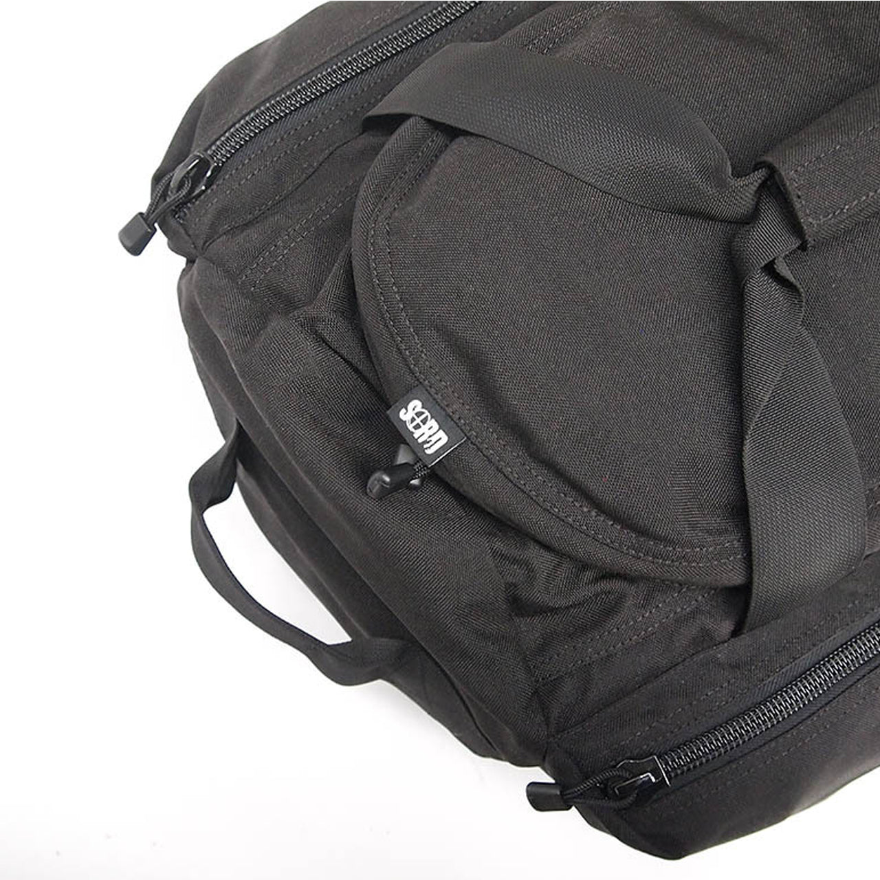 Constructed of heavy duty 1000 Denier Cordura, YKK #10 zips, Removable shoulder straps and "soft" seat belt carry straps for enhanced comfort and strength. Large main compartment with double zipped opening, two zipped side compartments. www.moralepatches.com.au