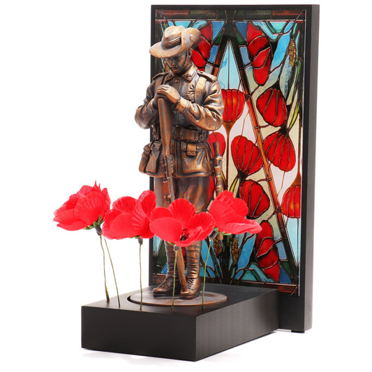 This beautifully crafted miniature figurine is a poignant tribute to our fallen soldiers. It comes with a striking acrylic backdrop, featuring an intricate stained-glass poppy design that adds depth and significance to the piece. www.moralepatches.com.au