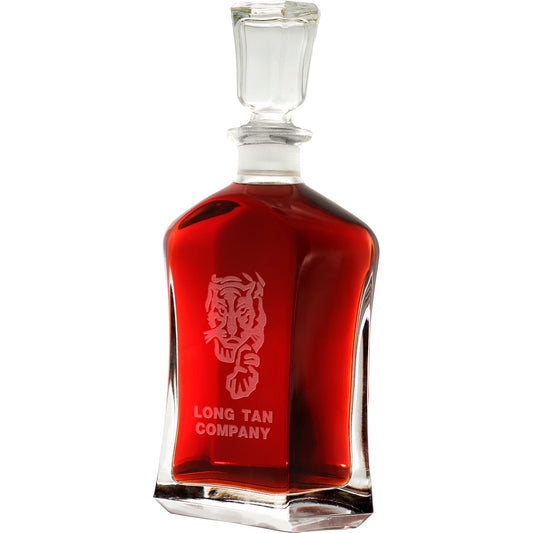 Bring your dining experience to life with the Long Tan Company Italian Glass Decanter. This elegant, 750ml decanter proudly displays the company crest, etched with precision onto the sleek glass surface. Perfect for gifting or displaying in your own cabinet or bar, this decanter is a must-have for any wine or spirit enthusiast. Enhance your evening with the beauty and quality of this stunning piece. www.moralepatches.com.au