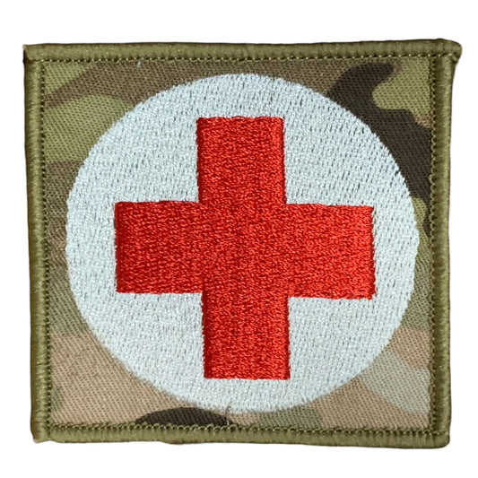 This Military Combat Patch, with the option of Plain or Velcro backing, is an essential for First Aid personnel in the field. Made from high-quality materials, this patch features an Australian-made field medical symbol and can easily be attached to First Aid Kits, Packs, or arm bands. Its exceptional quality is evident with overlocked edges and a size of 65mm x 65mm. Plus, it's proudly made in Australia using Multicam Fabric. www.moralepatches.com.au