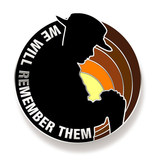 The Reversed Arms Lapel is a vibrant badge featuring the silhouette of a lone digger resting at reversed arms in front of a sunrise sky. This lapel pin is a moving addition to any lapel or coat and a wonderful commemorative piece. The words 'We Will Remember Them' are featured in silver detailing, adding to its unique design. www.moralepatches.com.au