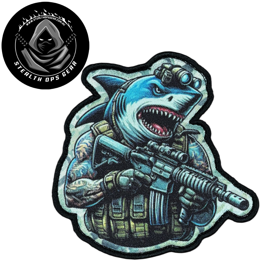 Unleash your creativity with the Shark Assault Embroidery Patch Hook &amp; Loop Stealth Ops Gear! Measuring 9x8.8cm and featuring a beautifully embroidered design and secure hook &amp; loop backing, this patch is a must-have for any collector. www.moralepatches.com.au