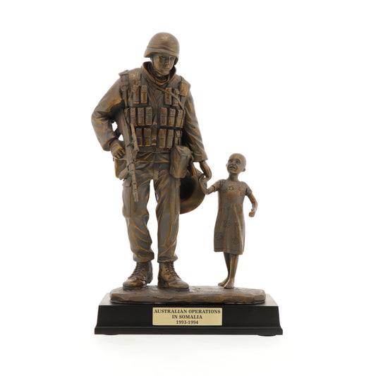 The Somalia Figurine is a sensational keepsake that pays tribute to the brave men and women who served our nation in Somalia. Inspired by Gary Ramage's iconic photograph, this figurine depicts a soldier helping a young girl, symbolizing the spirit of service and humanity. Standing at 30cm tall, this superb figurine is the perfect gift or collectable. www.moralepatches.com.au