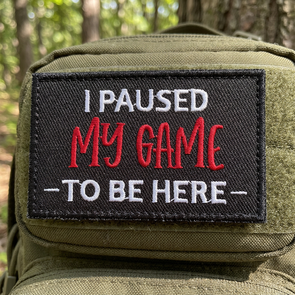 I Paused My Game To Be Here patch mounted on olive backpack