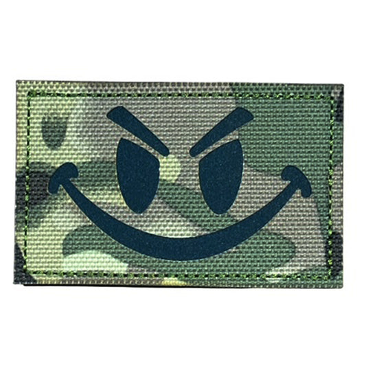 Make a bold statement with the Evil Smile Laser Cut Multicam Patch. This striking 8x5cm patch features laser-cut precision detailing that demands attention. Backed with both hook and loop fasteners, it's ready to attach to tactical gear, backpacks, or uniforms instantly. www.moralepatches.com.au