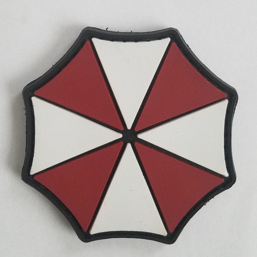 Resident Evil Umbrella PVC Patch, Velcro backed Badge. Great for attaching to your field gear, jackets, shirts, pants, jeans, hats or even create your own patch board.  Size: 6.5cm